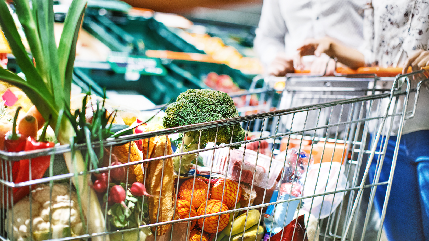 Grocery cart shown full of fruits and vegetables