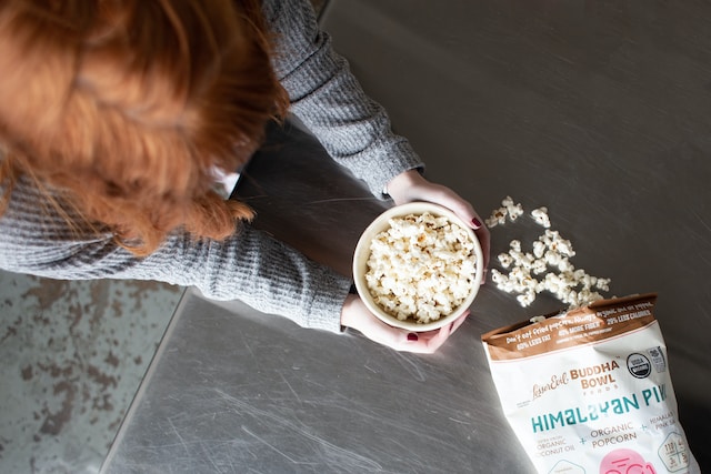 someone eating a late night snack of popcorn